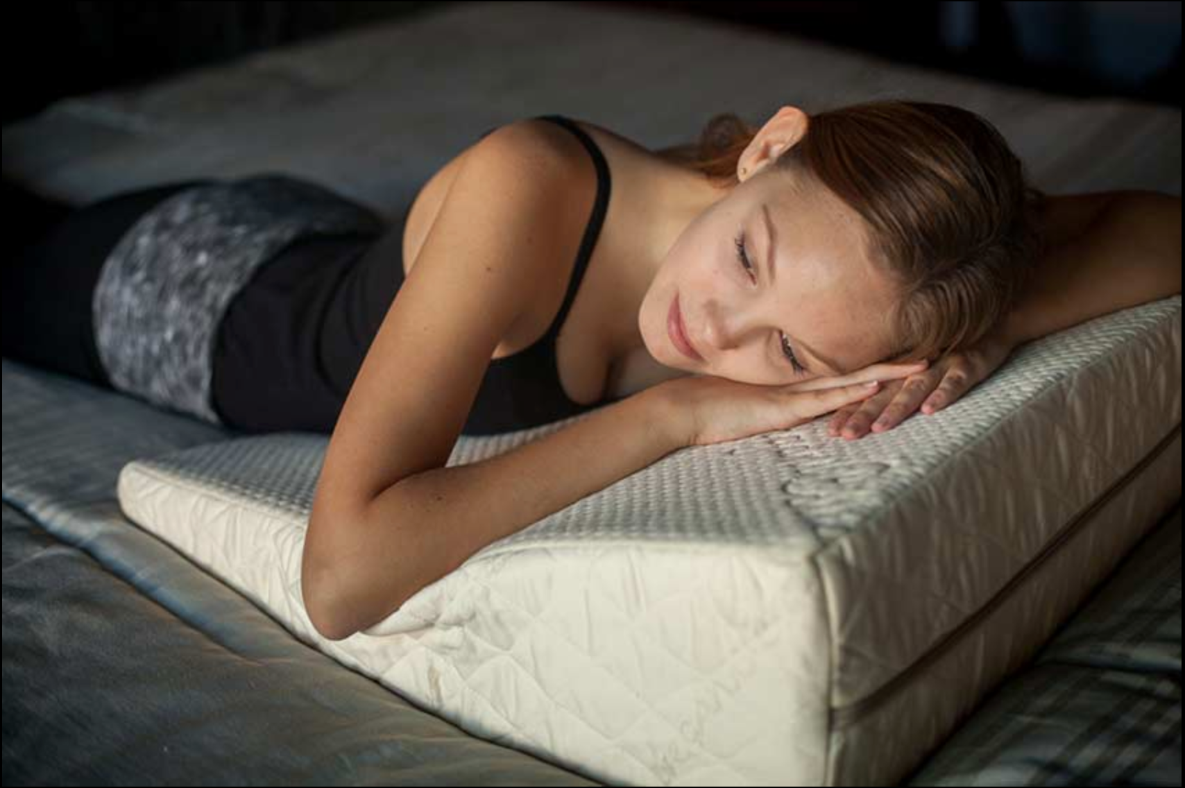 Image of the Loving Sleep Natural Latex Wedge Pillow with a woman laying her head on it