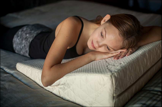 Image of the Loving Sleep Natural Latex Wedge Pillow with a woman laying her head on it